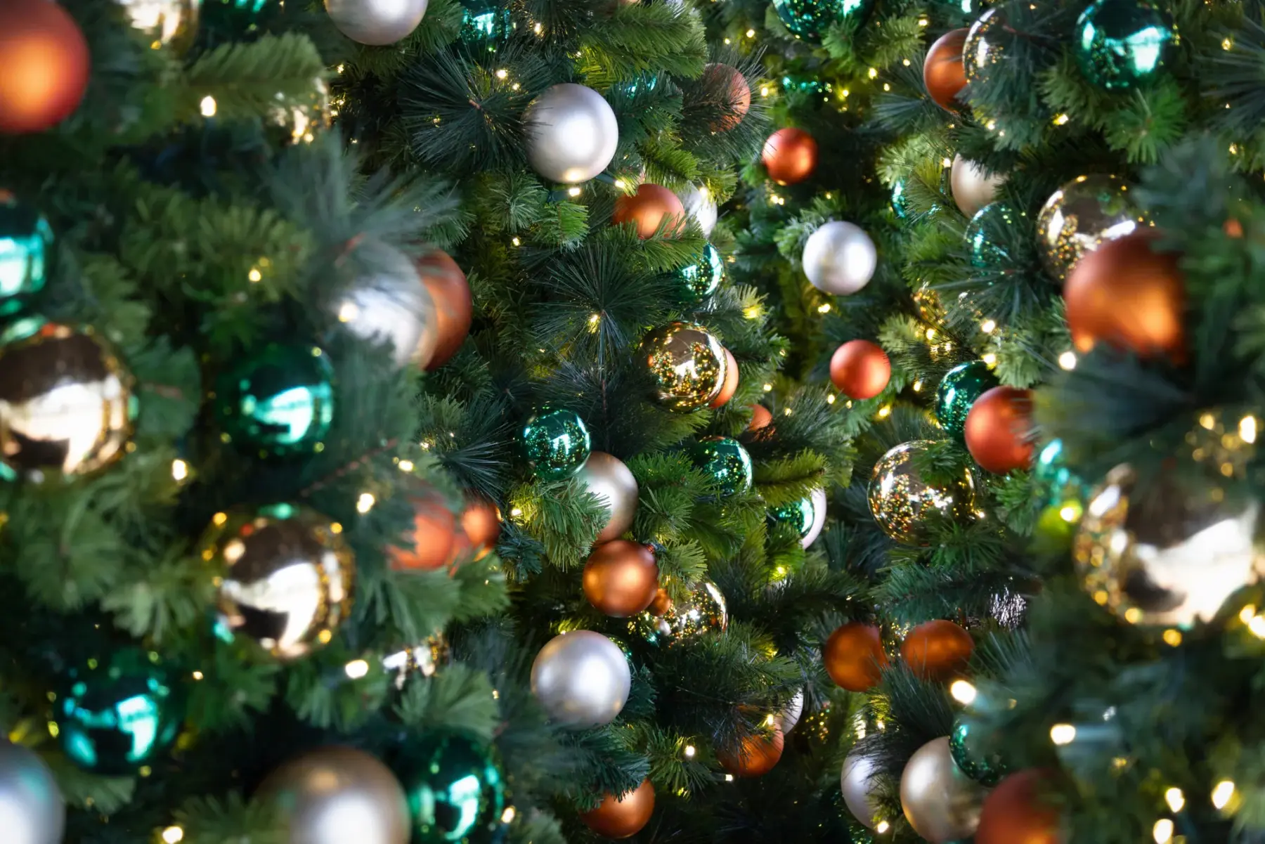 Lit garland pole wrap and street-light décor on a downtown street