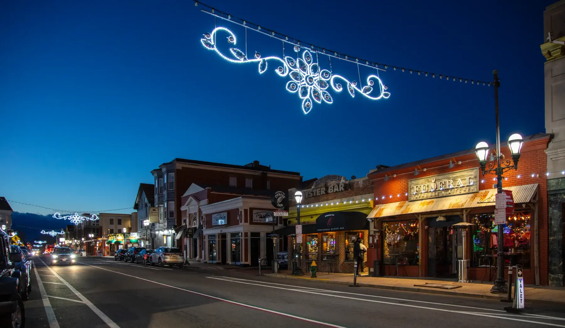 Illuminated LED snowflake pole motif mounted on a street light