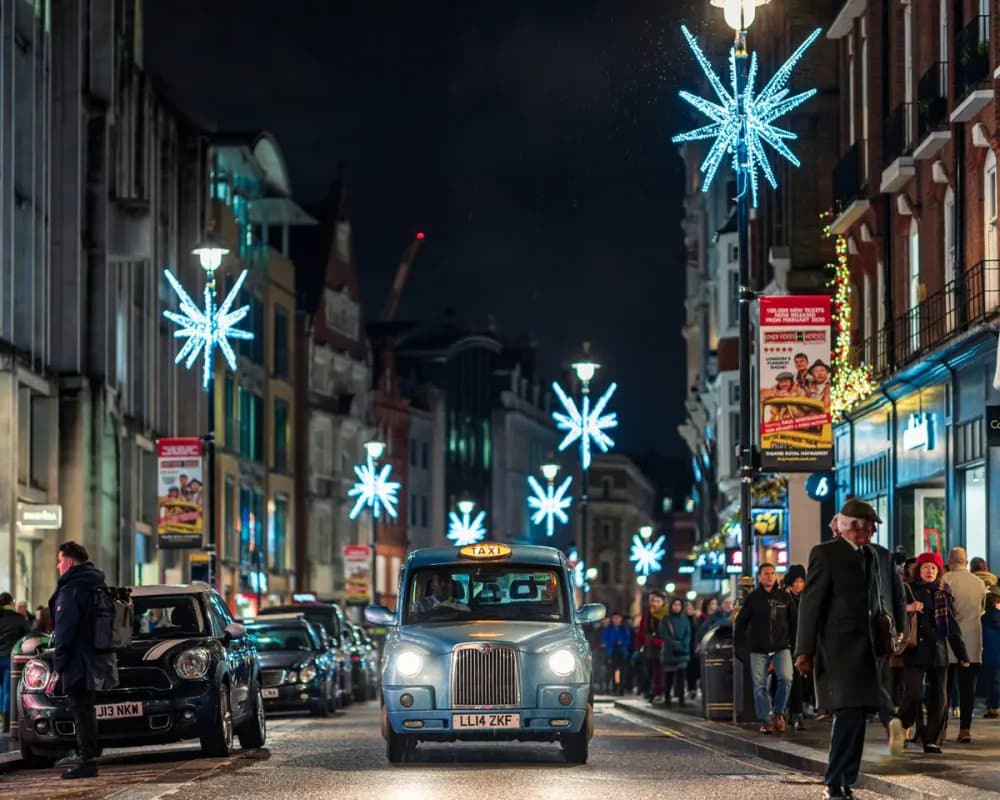 Illuminated LED snowflake pole motif mounted on a street light