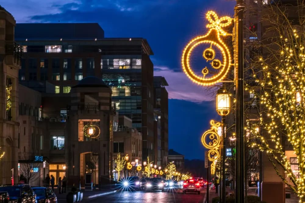 Illuminated LED snowflake pole motif mounted on a street light