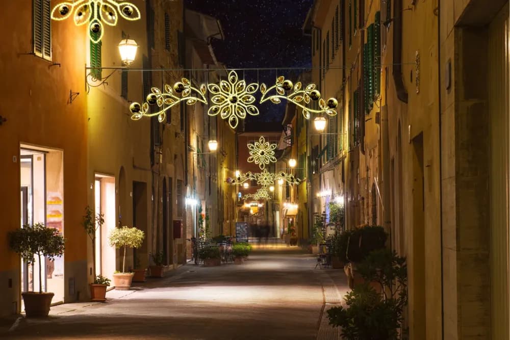 Illuminated LED snowflake pole motif mounted on a street light
